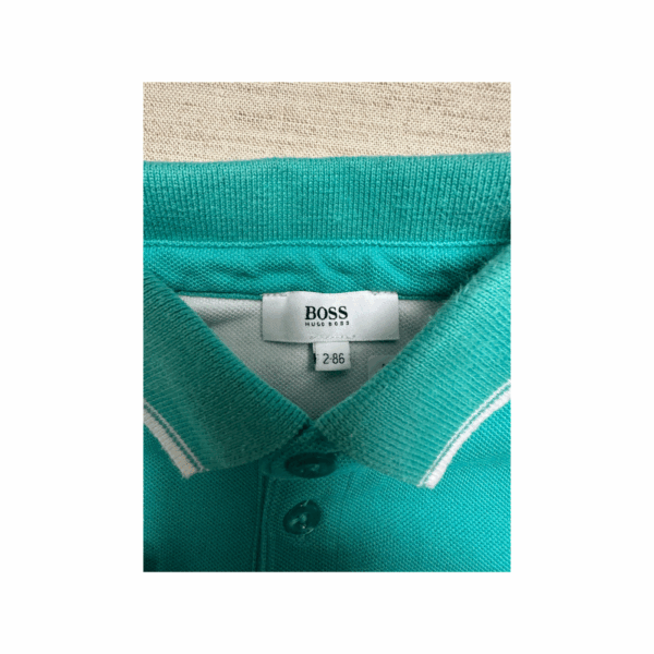 Seconde main Boss parfait état polo coton turquoise 2 ans
